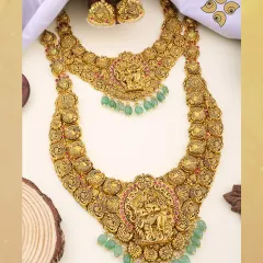 A masterpiece from our heritage collection, this double-layered temple jewellery set features detailed carvings of Lord Krishna in antique-finish 22kt gold. It is a highly sought-after design for the luxury bridal market.