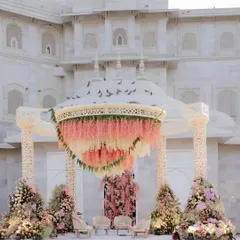 An absolutely dreamy mandap we designed at Fairmont Jaipur, featuring a canopy of cascading pink and white wisteria against the palace's white architecture. This is royal wedding decor at its finest.