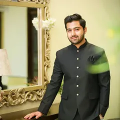 This client looks sharp and elegant in a classic black Jodhpuri suit. My grooming service included styling his hair with a clean side part and applying subtle makeup to ensure he looked his best for the event.