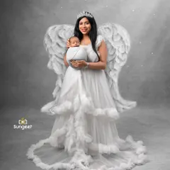 From maternity angel to a mother holding her little angel. This photo is from a newborn session, continuing the theme from the mother's pregnancy shoot.