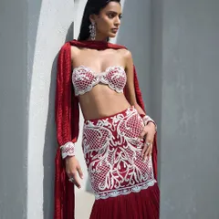 A pearl-embroidered lehenga in a crimson hue, featuring a sculpted bralette and a crushed dupatta. This look is a whole mood, blending tradition with a contemporary edge.