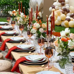 I can arrange a stunning backyard sundowner for a birthday celebration. This long table setup features warm terracotta tones, copper wine glasses, and beautiful floral centerpieces, creating a chic and inviting ambiance.