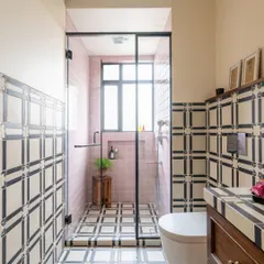 Bathrooms are mood-lifters, and this one was designed to feel both timeless and playful. By combining bold, graphic tiles with soft pink and warm wood, we created a personal sanctuary within a larger family home. It shows how thoughtful detailing can transform even the most functional spaces into something special.