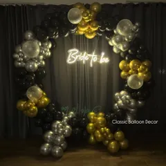 The same 'Bride to be' backdrop shown in low light, highlighting the effect of the bright neon sign. This creates a perfect, glamorous atmosphere for evening celebrations.