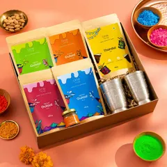 A vibrant flatlay of a Holi-themed gift box. We arranged the colorful herbal gulal packs, Thandai mix, and traditional glasses in a beautiful composition, surrounded by loose colors to capture the joyful spirit of the festival.
