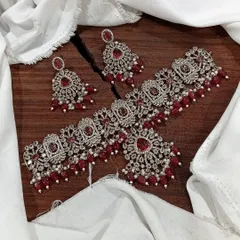 My premium Victorian choker sets are perfect for adding vintage elegance to your bridal or festive look. This particular set features intricate silver work studded with brilliant stones and rich red bead drops.