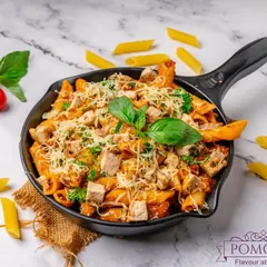 A pan of my signature pink sauce pasta, generously topped with cheese and fresh basil. This dish is a favourite at parties, combining the richness of white sauce and the tang of red sauce for a perfect balance.