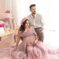 A dreamy, romantic portrait of a couple in our studio. The soft mauve gown, floral crown, and light-filled setup create an ethereal and gentle atmosphere, perfectly capturing their connection.