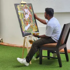 My setup is simple: an easel, a canvas, and my paints. I find a spot at the event where guests can watch as I transform a blank canvas into a piece of personalized art.