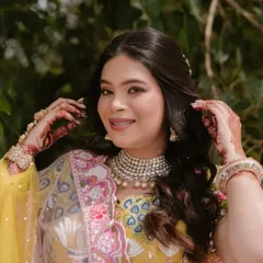 A close-up of the bride's happy face, showing her dewy skin and the subtle makeup that lets her personality shine.