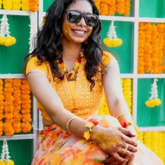 A cool and happy bride enjoying her Haldi ceremony. The sunglasses add a fun, modern twist to the traditional event, and her smile is absolutely infectious.
