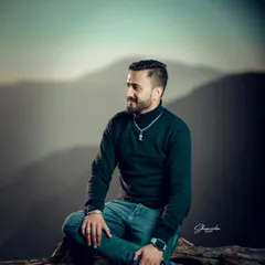 A relaxed outdoor portrait with a beautiful mountain silhouette in the background. Using high-speed sync allows me to create that soft, blurred background even in daylight.