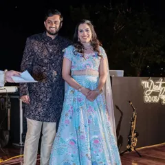The bride and groom on their Sangeet stage, sharing a smile. We ensure the lighting and backdrop are perfect for capturing these precious memories.