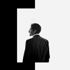 A creative black and white groom portrait with a bold graphic border. This artistic style is perfect for creating a standout image that feels like a magazine cover.