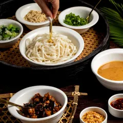 Bold, spicy, and unforgettable. Our Sichuan Dan Dan Noodles feature a complex, layered sauce with the perfect kick, served over noodles and garnished with fresh herbs and chili.