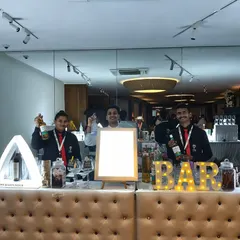 Our team proudly presenting our tufted bar with illuminated 'BAR' sign and triangular LED displays. This setup is clean, professional, and fully customizable.