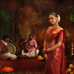 A closer look at the elegant drape on this red silk saree for a Pothys campaign. The pleats are kept sharp and the pallu is styled to create a regal look.