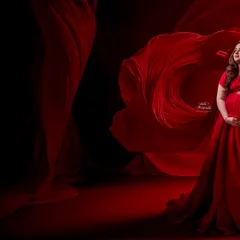 The power and beauty of motherhood captured in a single frame. We use dramatic lighting and flowing red fabric to create this breathtaking, high-fashion look in the studio.
