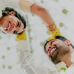 A low-angle "pov" shot capturing the couple during the talambralu ritual. It's an intimate, artistic perspective on a beautiful tradition, showing the pure happiness between two people.