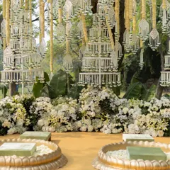 A stunning backdrop of hanging floral chandeliers made from delicate white flowers, creating a dreamy and fragrant setting for the Haldi rituals.