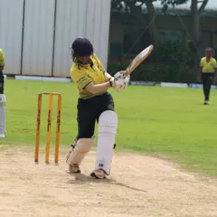 A young cricketer from our women's program executes a powerful shot during a match. We focus on developing strong technical fundamentals for batting in all our players.