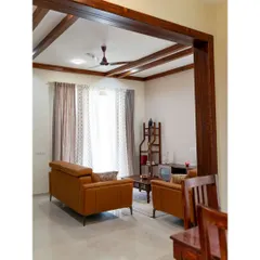 An alternate view of the living room, showing how the solid pine wood rafters and door frame create a beautiful, cohesive look that guides the eye through the space, connecting the living and dining areas.