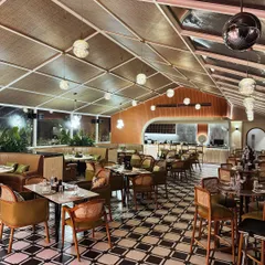 The main dining hall at Tipsy Town in Ayodhya. I used a mix of checkered flooring, a rattan-paneled ceiling, and warm terracotta tones to create a vibrant yet elegant atmosphere.