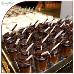 A close-up of my rich and creamy chocolate mousse cups. Topped with chocolate shavings and a decorative straw, these individual desserts are both elegant and delicious.