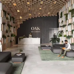 The lobby of the Oak tower at Sky Gardens introduces the project's biophilic theme with a pixelated wall of wood and stone planters, bringing nature into the arrival experience.