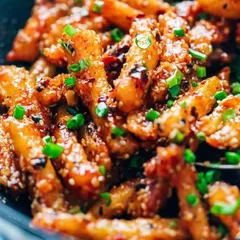 A crowd-pleasing starter, our Honey Chili Potatoes are crispy, sweet, and spicy. Tossed in a savory sauce with sesame seeds and spring onions, they are perfect for any celebration.