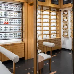 Reflective mirrors add depth and intrigue, enhancing the overall ambiance of the retail space. The design seamlessly fuses sleek architectural elements with organic textures.