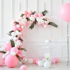 A delicate and pretty balloon arch in shades of pink and white, perfect for a first birthday or a baby shower. I incorporated white flowers and green leaves into the garland to give it a soft, organic feel against the clean white wall.