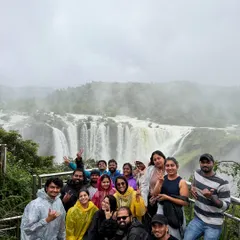 The whole group celebrating their visit to the magnificent Jog Falls during peak monsoon season.