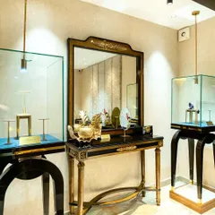 The display arrangement is crucial in a retail setting. I designed this area with freestanding glass vitrines and a classic console table, using focused pendant and track lighting to make the jewelry sparkle and capture attention.