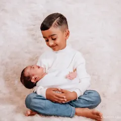 The sweet, gentle bond between siblings is one of my favorite things to photograph. This quiet moment between a big brother and his new baby sibling is simply precious.