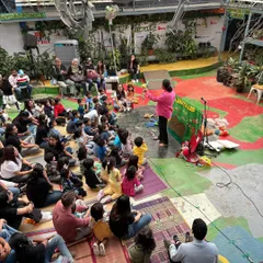 I can turn any space, big or small, into a theatre of imagination. Here I am at a school event, sharing a story with over a hundred families. It brings me so much joy to see both kids and parents completely absorbed in the performance together.