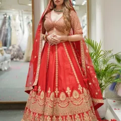 This classic red bridal lehenga features a beautiful A-line silhouette with traditional gold motifs along the border and a sequined blouse. It’s a timeless choice for your pheras.