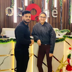 A member and trainer posing together at our decorated reception desk. The festive decorations and smiling faces capture the warm community spirit during the holidays.
