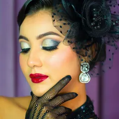 With eyes closed, you can appreciate the artistry of the silver and black eyeshadow blend. This demonstrates precision and control with bold pigments.