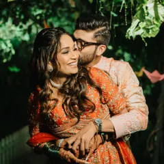 A sweet kiss and a happy smile. This candid portrait from the Haldi ceremony captures the genuine love and affection between the couple.