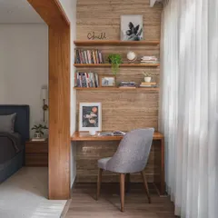 We transformed a small bedroom extension into this cozy and productive study area. The travertine-style wall paneling and wooden desk create a warm, natural feel, while the open shelves are perfect for books and personal items.