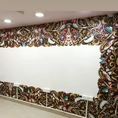 A more intricate and colorful wallpaper design for a salon. This custom piece frames a large mirror area, creating a vibrant and energetic focal point for the space.