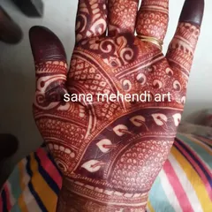 A close-up of a deep, rich henna stain on the palm. The contrast between the dark pattern and the skin is absolutely beautiful.