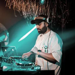 A candid shot of me working the turntables. The right track at the right time can change the entire mood of a party, and that's the craft I've dedicated myself to.