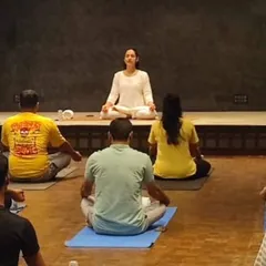 I guide a corporate group through a calming meditation session. My goal in these office wellness programs is to create a peaceful space for employees to disconnect from stress and reconnect with their inner calm, improving focus and well being.