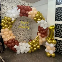 This elegant ring setup is perfect for a first birthday. I used a neutral color palette of brown, beige, and white, with a gold "Happy Birthday" sign and a number '1' balloon arrangement.
