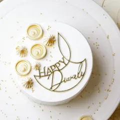 Wishing everyone a Happy Diwali with this elegant diya topper. I designed this piece in a minimalist line-art style, finished in mirror gold acrylic to add a modern yet festive touch to this beautiful all-white cake by Truffles Bangalore.