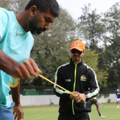 A close-up of our hands-on work. Here, I am guiding an athlete through a resistance band exercise, paying close attention to form and muscle activation. This precision is key to effective rehabilitation.