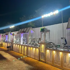 This is a look at one of my full-scale outdoor buffet setups. I use custom-built counters with elegant carvings and warm lighting to create a grand and inviting dining experience that complements the celebration, no matter the size of your guest list.