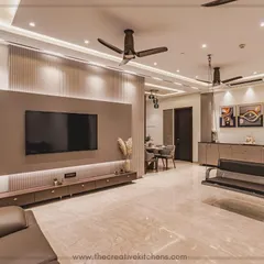 This wide view showcases how we harmonize different elements within a single space. The PU-finished TV unit and console are designed in a cohesive caffeinated palette, complemented by a modern swing and strategic lighting to create a cozy yet expansive living area.